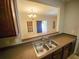 Kitchen sink with stainless steel basin and faucet, with a view into the living area at 1059 Sims Sw St, Atlanta, GA 30310