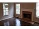 Cozy living room featuring a fireplace, windows, and hardwood floors at 1059 Sims Sw St, Atlanta, GA 30310