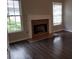 Cozy living room featuring hardwood floors, natural light, and a classic fireplace at 1059 Sims Sw St, Atlanta, GA 30310