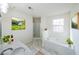 Large bathroom with double marble vanity, soaking tub, separate shower and natural light at 2196 Sandell Sw Trl, Marietta, GA 30008