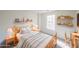 Cozy bedroom with wood bed frame, neutral decor, and natural light from a window at 2196 Sandell Sw Trl, Marietta, GA 30008