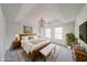 Comfortable main bedroom with tray ceiling, bed, and rustic wood furniture at 2196 Sandell Sw Trl, Marietta, GA 30008