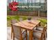 Inviting outdoor wooden table and chairs on a grassy lawn with landscaping allowance sign at 2196 Sandell Sw Trl, Marietta, GA 30008