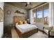 Cozy bedroom featuring an accent wall, large window, and comfortable bed at 245 N Highland Ne Ave # 210, Atlanta, GA 30307