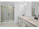 Modern bathroom with double vanity, sleek hardware, a glass-enclosed shower, and contemporary fixtures at 3186 Eastham Run Dr, Dacula, GA 30019
