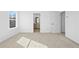 Neutral bedroom featuring new carpeting, white walls, and an open doorway to a connecting room at 3186 Eastham Run Dr, Dacula, GA 30019