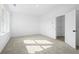 A well-lit room with gray carpeting and white trim, illuminated by natural light from multiple windows at 3186 Eastham Run Dr, Dacula, GA 30019