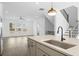 Bright kitchen features gray cabinets, stainless steel appliances, a large island with sink and hardwood floors at 3186 Eastham Run Dr, Dacula, GA 30019