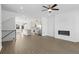 Bright open concept featuring kitchen with stainless steel appliances, living room with fireplace, and hardwood floors at 3186 Eastham Run Dr, Dacula, GA 30019