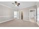 Bedroom with neutral walls, carpeted flooring, a ceiling fan, and access to walk-in closet at 8111 Lawnview Dr, Alpharetta, GA 30022