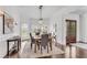 Formal dining room with hardwood floors, chandelier, and view of front yard at 8111 Lawnview Dr, Alpharetta, GA 30022