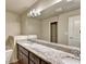 Bathroom featuring double sink vanity with granite countertop, dark cabinets, and chrome fixtures at 3082 Cedar Glade Ne Ln, Buford, GA 30519