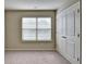 A bright bedroom featuring plush carpeting, a double window and a double door closet at 3082 Cedar Glade Ne Ln, Buford, GA 30519