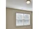 A bright bedroom featuring a large double window for natural light and neutral walls at 3082 Cedar Glade Ne Ln, Buford, GA 30519