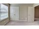 The bedroom has plush carpet, a double-door closet, and large window for natural light at 3082 Cedar Glade Ne Ln, Buford, GA 30519