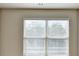 A bright bedroom featuring a large double window for natural light and neutral walls at 3082 Cedar Glade Ne Ln, Buford, GA 30519