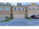 Charming townhome with a two-car garage and stone accents on the facade at 3082 Cedar Glade Ne Ln, Buford, GA 30519