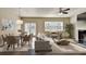 Bright living room with fireplace, ceiling fan, neutral decor, and dining area at 3082 Cedar Glade Ne Ln, Buford, GA 30519