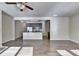 Open-concept living room featuring an adjacent kitchen with stainless steel appliances at 3082 Cedar Glade Ne Ln, Buford, GA 30519