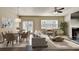 Bright, open-concept living and dining room featuring a fireplace and modern furnishings at 3082 Cedar Glade Ne Ln, Buford, GA 30519