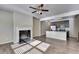 Open-concept living room featuring a fireplace and view of the kitchen with stainless steel appliances at 3082 Cedar Glade Ne Ln, Buford, GA 30519