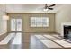 Bright living room featuring wood floors, large windows, and a cozy fireplace at 3082 Cedar Glade Ne Ln, Buford, GA 30519