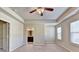 A spacious main bedroom features a ceiling fan and plush carpet and ensuite bathroom at 3082 Cedar Glade Ne Ln, Buford, GA 30519