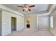 A spacious main bedroom features a ceiling fan and plush carpet, a walk-in closet, and ensuite at 3082 Cedar Glade Ne Ln, Buford, GA 30519