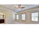 A spacious main bedroom features a ceiling fan and plush carpet and ensuite bathroom at 3082 Cedar Glade Ne Ln, Buford, GA 30519