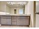 Bathroom features a double sink vanity with gray cabinets, granite countertops and modern light fixtures at 3082 Cedar Glade Ne Ln, Buford, GA 30519