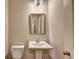 Bathroom with a pedestal sink and decorative mirror at 3082 Cedar Glade Ne Ln, Buford, GA 30519