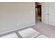 Spacious bedroom with neutral walls, carpet floors, and a doorway to another room at 3082 Cedar Glade Ne Ln, Buford, GA 30519