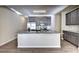 Open kitchen featuring stainless steel appliances, gray cabinets and a large granite island at 3082 Cedar Glade Ne Ln, Buford, GA 30519