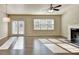 Bright living room featuring a fireplace, hardwood floors, and plenty of natural light at 3082 Cedar Glade Ne Ln, Buford, GA 30519