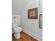 Powder room featuring toilet, decorative artwork, and modern finishes at 127 Old Alabama Road Se, Emerson, GA 30137