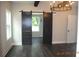 Elegant dining room featuring sliding barn doors, dark wood floors, and a chandelier at 127 Old Alabama Se Rd, Emerson, GA 30137