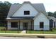 Charming single-Gathering home featuring a modern farmhouse design with a black metal fence and lush green lawn at 127 Old Alabama Se Rd, Emerson, GA 30137