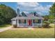 Charming single-story home featuring a manicured lawn and a bright red front door at 1743 Wee Kirk Se Rd, Atlanta, GA 30316