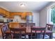 Eat-in kitchen with stainless steel appliances, wooden cabinets, and a large dining table at 1743 Wee Kirk Se Rd, Atlanta, GA 30316