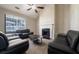 Bright living room featuring a fireplace, large window, and black leather sofas at 1743 Wee Kirk Se Rd, Atlanta, GA 30316