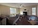 Bright living room with a fireplace, ceiling fan, and a door to the backyard at 2625 Thunder Basin Way, Douglasville, GA 30135