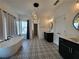 Bright bathroom features decorative tile floor, a freestanding tub, and contemporary lighting at 3794 Allegretto Cir, Atlanta, GA 30339