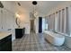 Bright bathroom features decorative tile floor, a freestanding tub, and contemporary lighting at 3794 Allegretto Cir, Atlanta, GA 30339