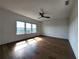 Light-filled bedroom with hardwood flooring and view overlooking natural surrounding landscape at 3794 Allegretto Cir, Atlanta, GA 30339