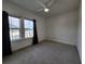 Bright bedroom with neutral carpet, two windows, and a ceiling fan provides a simple canvas for personal style at 3794 Allegretto Cir, Atlanta, GA 30339