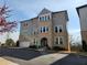 Beautiful three-story townhome with attached garage and manicured landscaping at 3794 Allegretto Cir, Atlanta, GA 30339