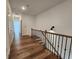Hallway with wood floors and wrought iron railing at 3794 Allegretto Cir, Atlanta, GA 30339