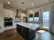 Modern kitchen features a large center island, pendant lighting, and stainless steel appliances at 3794 Allegretto Cir, Atlanta, GA 30339