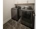 Laundry room features gray tile floor and stainless steel washer and dryer at 3794 Allegretto Cir, Atlanta, GA 30339