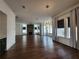 Open floor plan featuring a modern fireplace, hardwood floors, and large windows at 3794 Allegretto Cir, Atlanta, GA 30339